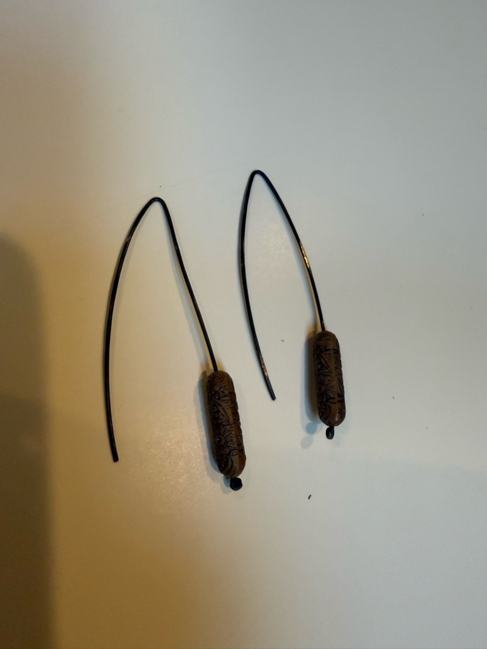 Long Black Wire Earrings with Brown Carved Beads